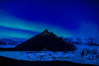 Aurora over a mountain and glacier 