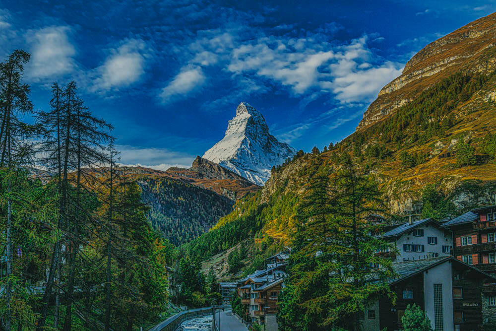 Enchanted Sentinel An enchanting view from Zermatt of the Matterhorn with amazing fall colors displayed in the trees and mountains including a fascinating...